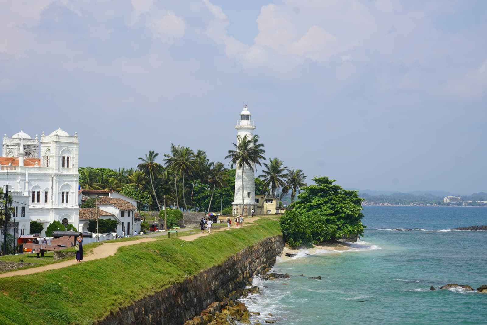 Galle Fort lighthouse and ramparts along the ocean at golden hour